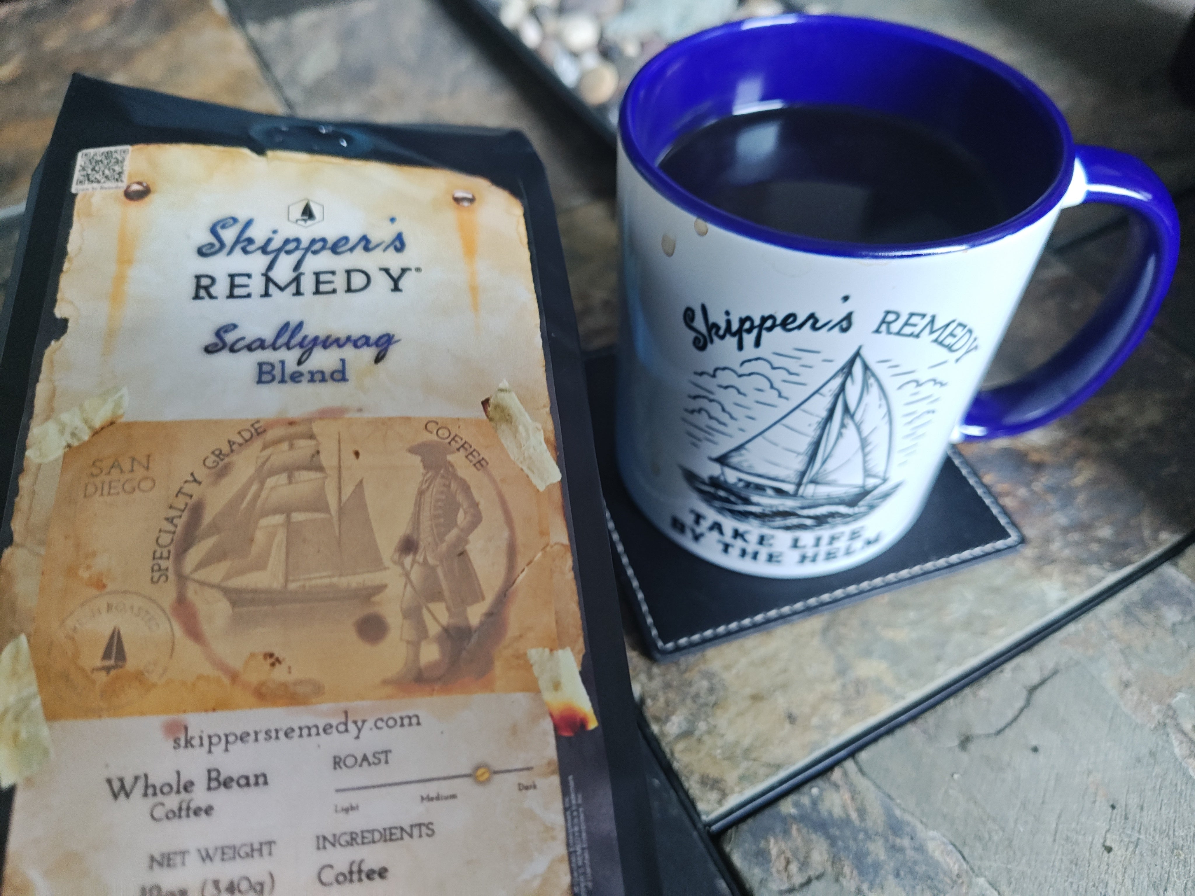 Scallywag Blend, from Skippers Remedy, and a coffee mug on a stone surface